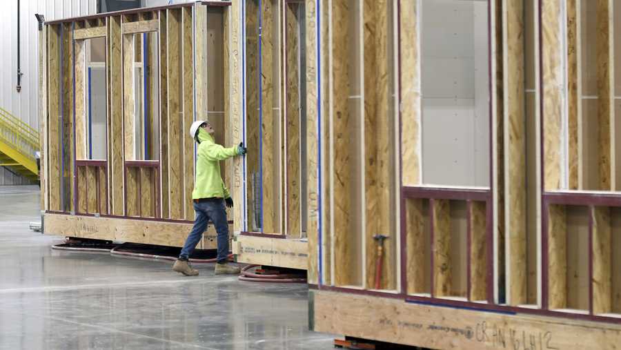 A worker inspects the framing of a modular home at the Fading West factory in Buena Vista, Colo., on Feb. 19, 2025. (AP Photo/Thomas Peipert)