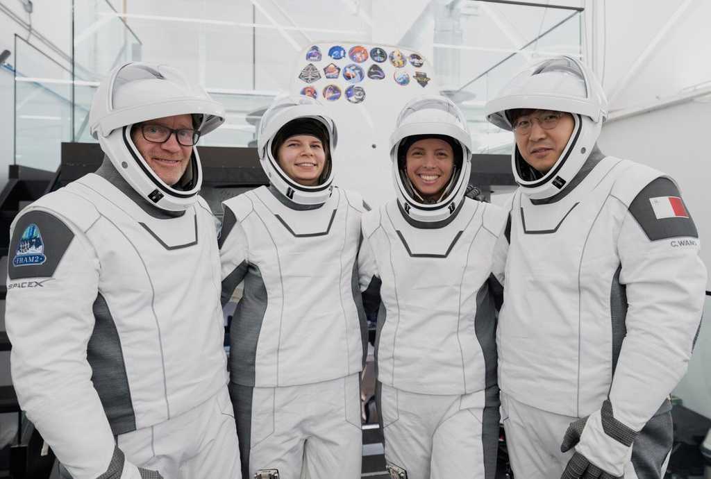 Space tourists return after polar orbit