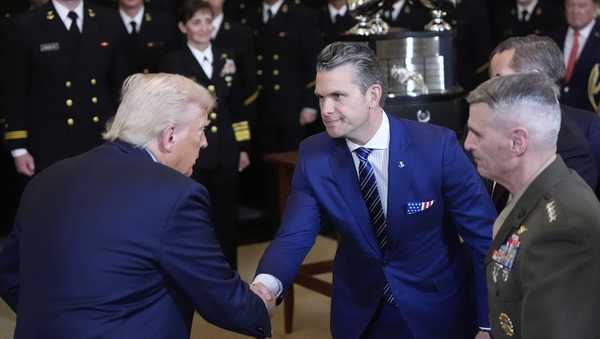 President Donald Trump shakes hands with Defense Secretary Pete Hegseth at the Commander-in-Chief trophy presentation to the Navy Midshipman football team in the East Room of the White House, Tuesday, April 15, 2025, in Washington. (AP Photo/Alex Brandon)