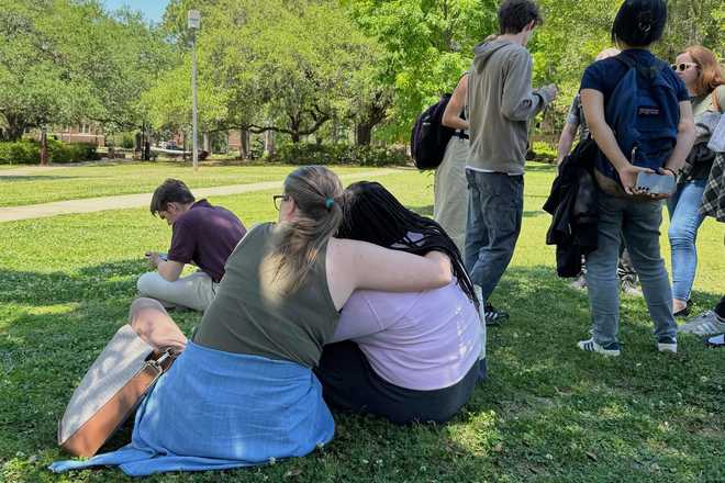 People comfort each other on Florida State University’s campus in Tallahassee, where law enforcement responded to a reported active shooter incident Thursday, April 17, 2025