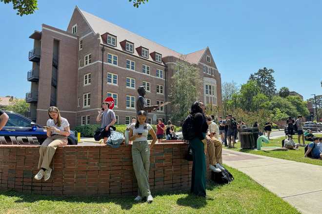 People comfort each other on Florida State University’s campus in Tallahassee, where law enforcement responded to a reported active shooter incident Thursday, April 17, 2025.