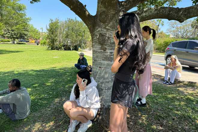 People comfort each other on Florida State University’s campus in Tallahassee, where law enforcement responded to a reported active shooter incident Thursday, April 17, 2025.