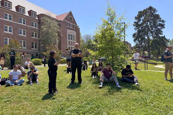 People comfort each other on Florida State University’s campus in Tallahassee, where law enforcement responded to a reported active shooter incident Thursday, April 17, 2025.