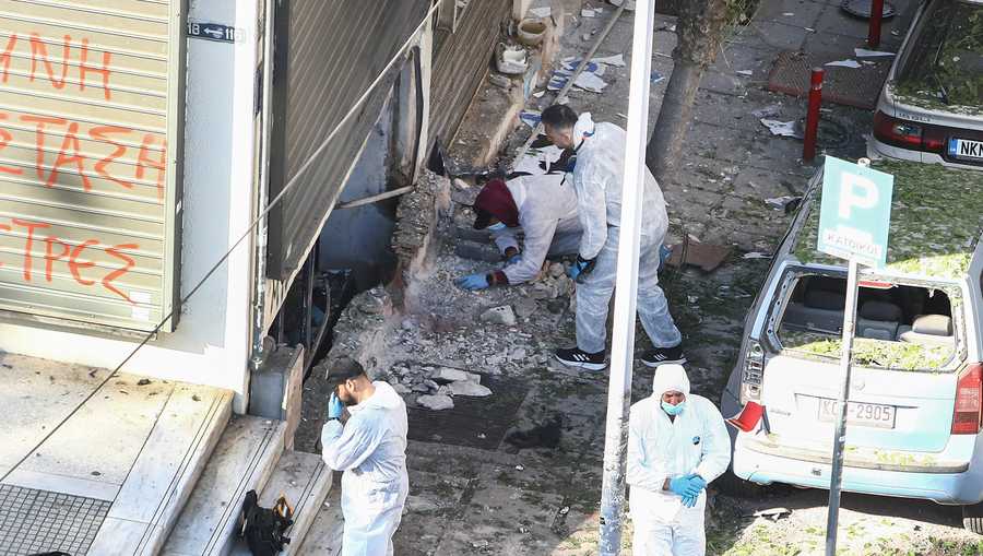 Greek police forensic experts search the spot where a 38-year-old woman was killed early Saturday when a bomb she was carrying exploded in her hands, local police said, in Thessaloniki, northern Greece, May 3, 2025.