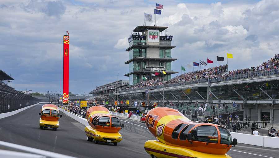 The Oscar Mayer Wienermobiles head into the first turn as they compete in the Wienie 500 following the practice session for the Indianapolis 500 auto race at Indianapolis Motor Speedway in Indianapolis, Friday, May 23, 2025. (AP Photo/Michael Conroy)
