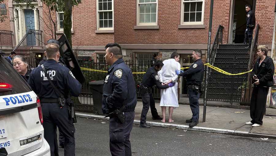 New York police officers arrest John Woeltz, Friday, May 23, 2025, in New York, who was charged with kidnapping, assaulting and holding a man against his will for several weeks in an upscale Manhattan town house.