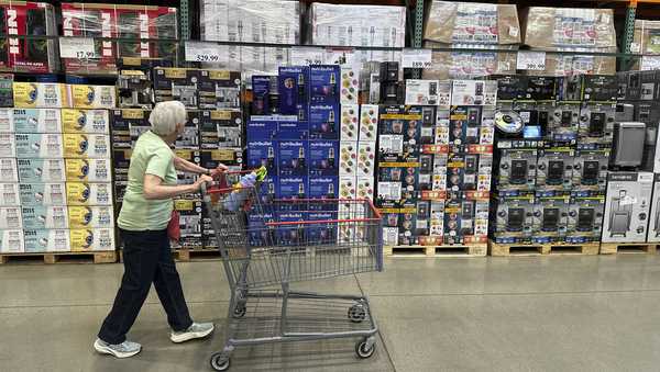 A shopper surveys goods on display in a Costco warehouse Wednesday, May 21, 2025, in Lone Tree, Colo. (AP Photo/David Zalubowski)