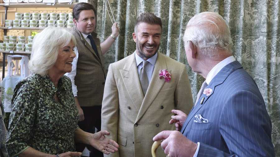 Britain&apos;s King Charles III and Queen Camilla speak with David Beckham at the Chelsea Flower Show in London, Monday May 19, 2025. (Toby Melville/Pool via AP)