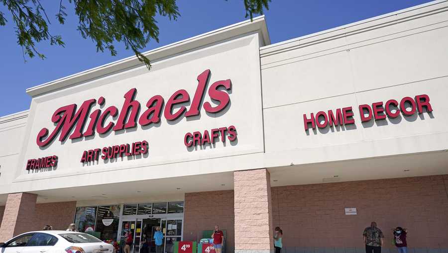 FILE - In this April 24, 2020 file photo, customers lineup outside a Michaels store in Houston. (AP Photo/David J. Phillip, File)