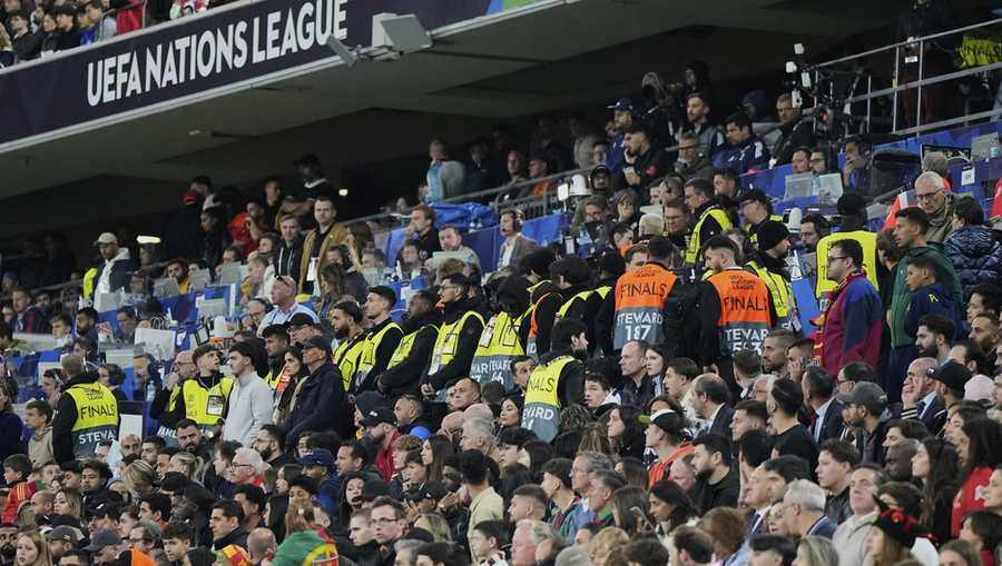 Match stewards form a line at the stands during the Nations League final soccer match between Portugal and Spain at the Allianz Arena in Munich, Germany, Sunday, June 8, 2025. (AP Photo/Martin Meissner)