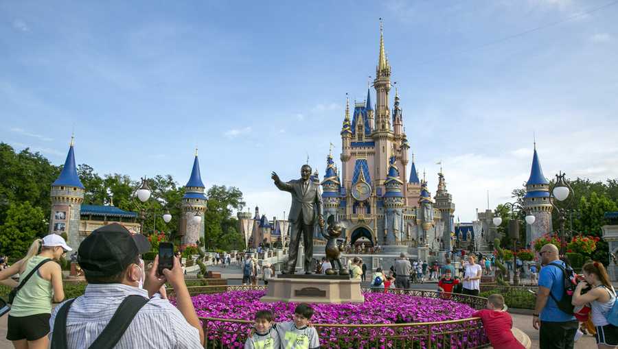 FILE - People visit the Magic Kingdom Park at Walt Disney World Resort in Lake Buena Vista, Fla., April 18, 2022. (AP Photo/Ted Shaffrey, File)