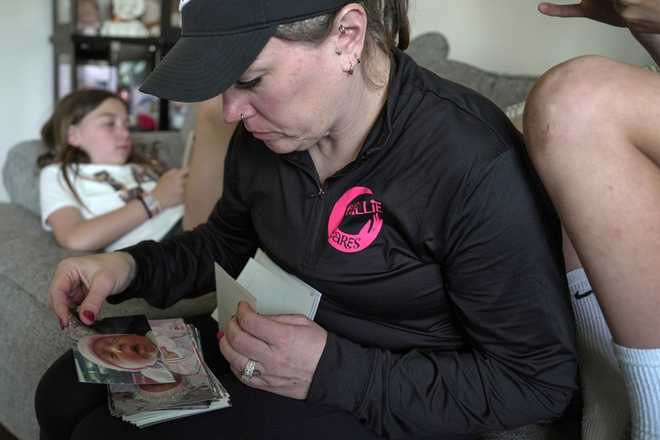 Katie&#x20;Van&#x20;Tornhout&#x20;looks&#x20;through&#x20;photos&#x20;of&#x20;her&#x20;late&#x20;daughter,&#x20;Callie,&#x20;at&#x20;home&#x20;in&#x20;Lakeville,&#x20;Ind.,&#x20;on&#x20;May&#x20;7,&#x20;2025.&#x20;&#x28;AP&#x20;Photo&#x2F;Shelby&#x20;Lum&#x29;