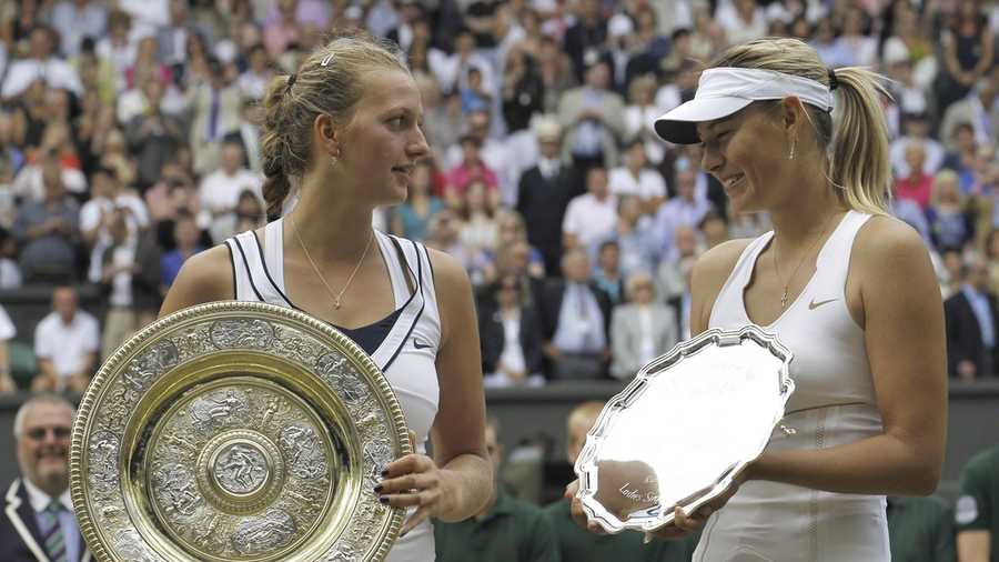FILE - Petra Kvitova, left, of the Czech Republic and Russia&apos;s Maria Sharapova hold their trophies after Kvitova won in the ladies&apos; singles final at the All England Lawn Tennis Championships at Wimbledon, July 2, 2011. (AP Photo/Anja Niedringhaus, file)