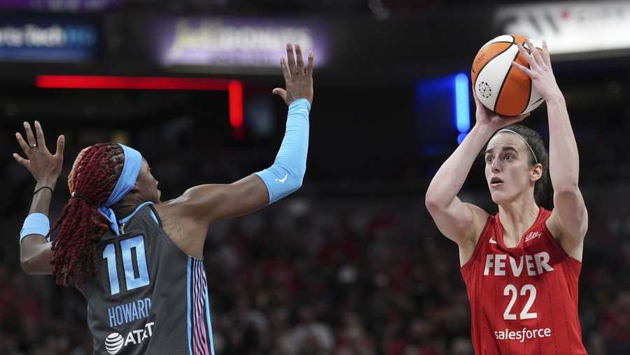 Indiana Fever&apos;s Caitlin Clark (22) shoots over Atlanta Dream&apos;s Rhyne Howard (10) during the second half of a WNBA basketball game, Friday, July 11, 2025, in Indianapolis. (AP Photo/AJ Mast)