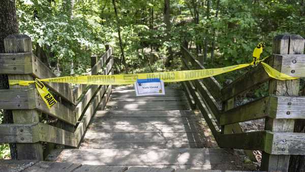 The trail head to the Devil's Den trail at Devils Den State Park remains closed Monday, July 28, 2025, in West Fork, Ark. Police in Arkansas are searching for a suspect in the deaths of a couple who investigators said were attacked while on the wooded walking trail with their two young daughters. (AP Photo/Michael Woods)