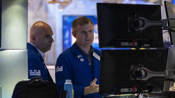 Traders work on the floor of the New York Stock Exchange, Friday, Aug. 1, 2025, in New York. (AP Photo/Yuki Iwamura)