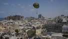Palestinians rush to collect humanitarian aid airdropped by parachutes into Gaza City, northern Gaza Strip, Thursday, Aug. 7, 2025.