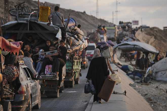 Displaced&#x20;Palestinians&#x20;fleeing&#x20;northern&#x20;Gaza&#x20;carry&#x20;their&#x20;belongings&#x20;along&#x20;the&#x20;coastal&#x20;road&#x20;toward&#x20;southern&#x20;Gaza,&#x20;Thursday,&#x20;Sept.&#x20;11,&#x20;2025,&#x20;after&#x20;the&#x20;Israeli&#x20;army&#x20;issued&#x20;evacuation&#x20;orders&#x20;from&#x20;Gaza&#x20;City.&#x20;&#x28;AP&#x20;Photo&#x2F;Jehad&#x20;Alshrafi&#x29;