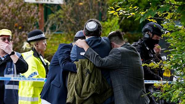 Members of the Jewish community comfort each other near to the Heaton Park Hebrew Congregation synagogue, in Crumpsall, Manchester, England, Thursday, Oct. 2, 2025 after Police reported that two people were killed and three others were seriously injured in a synagogue attack in northern England.
