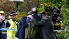Members of the Jewish community comfort each other near to the Heaton Park Hebrew Congregation synagogue, in Crumpsall, Manchester, England, Thursday, Oct. 2, 2025 after Police reported that two people were killed and three others were seriously injured in a synagogue attack in northern England. 