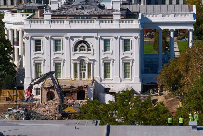 Construction&#x20;workers,&#x20;bottom&#x20;right,&#x20;atop&#x20;the&#x20;U.S.&#x20;Treasury,&#x20;watch&#x20;as&#x20;work&#x20;continues&#x20;on&#x20;a&#x20;largely&#x20;demolished&#x20;part&#x20;of&#x20;the&#x20;East&#x20;Wing&#x20;of&#x20;the&#x20;White&#x20;House,&#x20;Thursday,&#x20;Oct.&#x20;23,&#x20;2025,&#x20;in&#x20;Washington,&#x20;before&#x20;construction&#x20;of&#x20;a&#x20;new&#x20;ballroom.&#x20;&#x28;AP&#x20;Photo&#x2F;Jacquelyn&#x20;Martin&#x29;