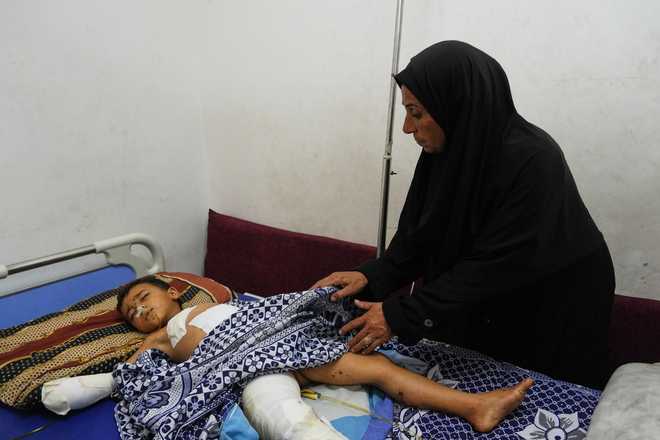 Hanan&#x20;Shakshk&#x20;cares&#x20;her&#x20;grandson&#x20;Yahya&#x20;Shorbasi,&#x20;who&#x20;was&#x20;injured&#x20;by&#x20;an&#x20;unexploded&#x20;ordnance&#x20;along&#x20;with&#x20;his&#x20;six-year-old&#x20;twin&#x20;sister&#x20;Nabila,&#x20;at&#x20;Shifa&#x20;Hospital&#x20;in&#x20;Gaza&#x20;City,&#x20;Saturday,&#x20;Oct.&#x20;25,&#x20;2025.&#x20;&#x28;AP&#x20;Photo&#x2F;Abdel&#x20;Kareem&#x20;Hana&#x29;