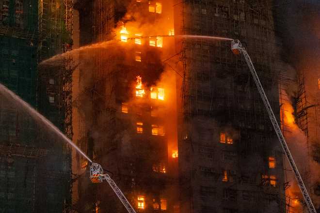 Firefighters&#x20;try&#x20;to&#x20;extinguish&#x20;a&#x20;flames&#x20;engulfing&#x20;a&#x20;building&#x20;after&#x20;a&#x20;fire&#x20;broke&#x20;out&#x20;at&#x20;Wang&#x20;Fuk&#x20;Court,&#x20;a&#x20;residential&#x20;estate&#x20;in&#x20;the&#x20;Tai&#x20;Po&#x20;district&#x20;of&#x20;Hong&#x20;Kong&amp;apos&#x3B;s&#x20;New&#x20;Territories,&#x20;Wednesday,&#x20;Nov.&#x20;26&#x20;2025.&#x20;&#x28;AP&#x20;Photo&#x2F;Chan&#x20;Long&#x20;Hei&#x29;