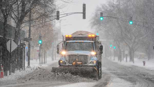 A plow clears snow from the road Saturday, Nov. 29, 2025, in Chicago. (AP Photo/Kiichiro Sato)