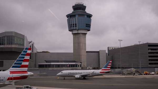 An American Eagle plane moves past the FAA Air Traffic Control tower at LaGuardia Airport (LGA) in the Queens borough of New York, Sunday, Nov. 9, 2025. (AP Photo/Adam Gray)