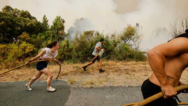 FILE - Local residents and volunteers work together to battle an encroaching wildfire in Larouco, northwestern Spain, Aug. 13, 2025. (AP Photo/Lalo R. Villar, File)