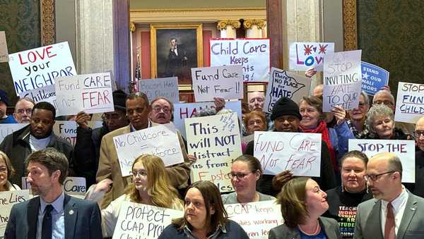 People gather for a news conference at the state capitol in St. Paul, Minn., on Wednesday, Dec. 31, 2025. (AP Giovanna Dell'Orto)