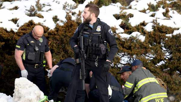 A Minneapolis police officer stands guard while emergency medical technicians administer aid to a person who was shot by a Immigration and Customs Enforcement officer in Minneapolis on Wednesday, Jan. 7, 2026.  (Ellen Schmidt/MinnPost via AP)