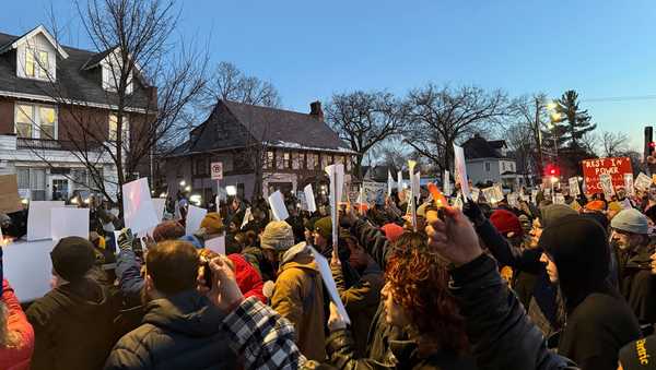 Demonstrators gather during a vigil near where an Immigration and Customs Enforcement officer shot and killed a woman in Minneapolis, Wednesday, Jan. 7, 2026. (AP Photo/Giovanna Dell'Orto)