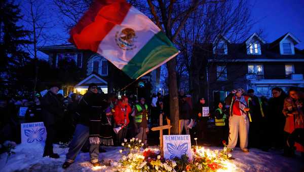 People gather for a vigil after an Immigration and Customs Enforcement officer shot and killed a woman earlier in the day, Wednesday, Jan. 7, 2026, in Minneapolis.