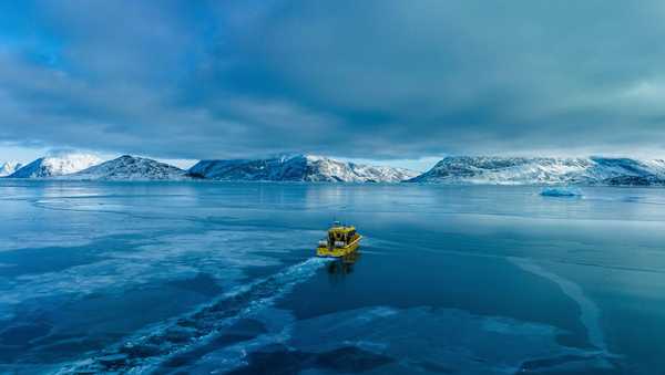 FILE - A boat rides though a frozen sea inlet outside of Nuuk, Greenland, on March 6, 2025. (AP Photo/Evgeniy Maloletka, File)