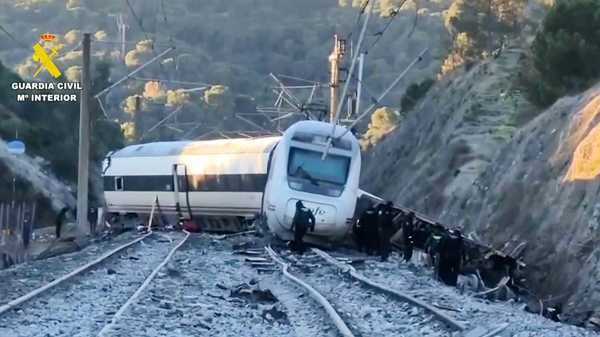 In this grab taken from video provided by Guardia Civil, rescue workers at the scene after a high speed train collision, in Adamuz, Spain, Monday, Jan. 19, 2026.