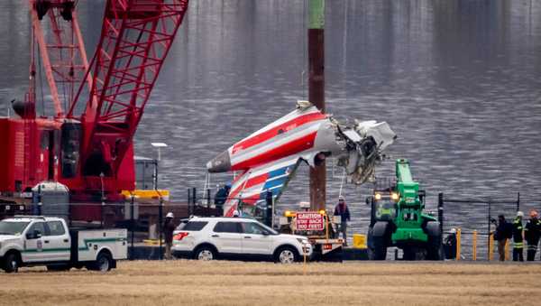 FILE - A crane offloads a piece of wreckage from a salvage vessel onto a flatbed truck, near the wreckage site in the Potomac River of a mid-air collision between an American Airlines jet and a Black Hawk helicopter, at Ronald Reagan Washington National Airport, Feb. 5, 2025, in Arlington, Va. (AP Photo/Ben Curtis, File)