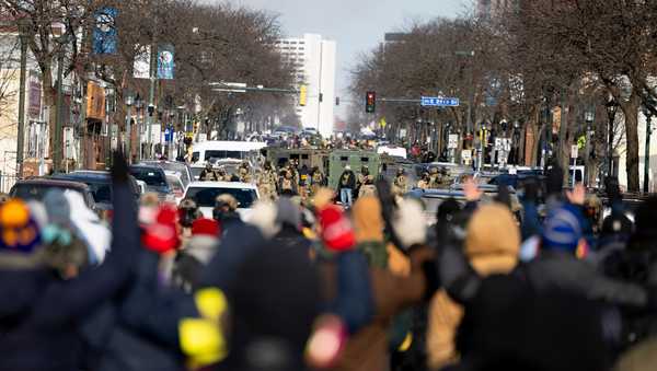 Protesters advance toward federal agents with their hands up near the site of the fatal shooting of 37-year-old Alex Pretti by federal agents in Minneapolis on Saturday, Jan. 24, 2026. (Ellen Schmidt/MinnPost via AP)