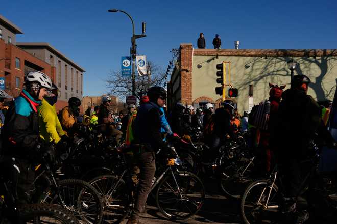 People gather for a solidarity bike ride for Alex Pretti and Renee Good on Saturday, Jan. 31, 2026 in Minneapolis. (AP Photo/Julia Demaree Nikhinson)
