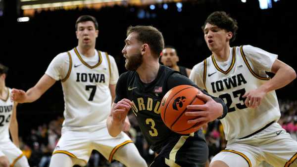 Purdue guard Braden Smith (3) drives to the basket past Iowa forward Alvaro Folgueiras (7) and guard Isaia Howard (23) during the first half of an NCAA college basketball game, Saturday, Feb. 14, 2026, in Iowa City, Iowa. (AP Photo/Charlie Neibergall)