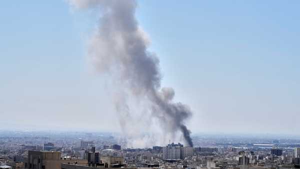 A plume of smoke rises after a strike in Tehran, Iran, Sunday, March 1, 2026. (AP Photo/Vahid Salemi)