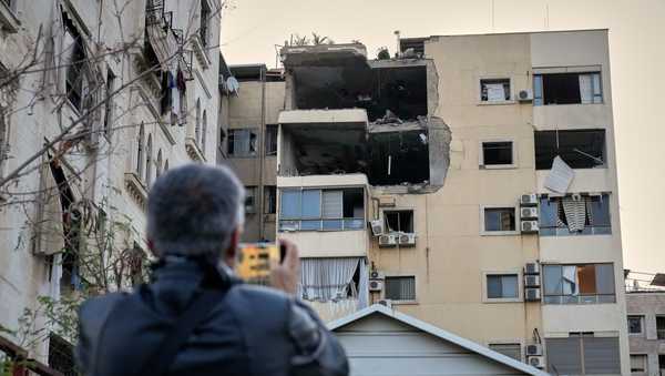 A man takes pictures of the damage in an apartment building after it was hit by an Israeli airstrike in Dahiyeh, Beirut's southern suburb, Lebanon, Monday, March 2, 2026.