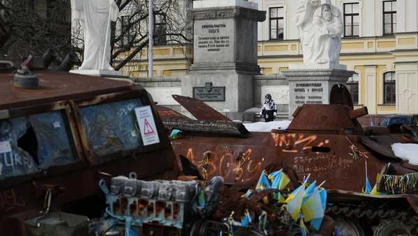 A child plays next to an open air exhibition of destroyed Russian military equipment in Kyiv, Ukraine, Saturday, Feb. 28, 2026. (AP Photo/Sergei Grits)