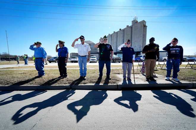Local VFW 738 members salute during a procession for Iowa National Guard members Maj. Jeffrey O&amp;apos;Brien, of Waukee, Iowa, and Sgt. Declan Coady, of West Des Moines, Iowa, who both died when a drone hit a command center in Port Shuaiba, Kuwait, during the Iran Israel U.S. war, in Des Moines, Iowa, Thursday, March 19, 2026. (AP Photo/Charlie Neibergall)