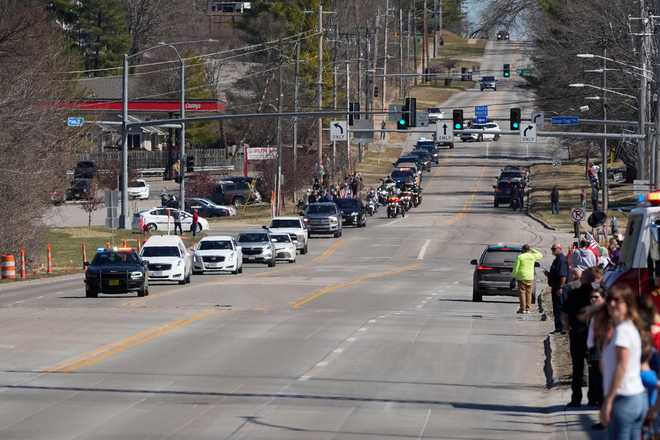 Community members look on during a procession for Iowa National Guard members Maj. Jeffrey O&amp;apos;Brien, of Waukee, Iowa, and Sgt. Declan Coady, of West Des Moines, Iowa, who both died when a drone hit a command center in Port Shuaiba, Kuwait, during the Iran Israel U.S. war, in Des Moines, Iowa, Thursday, March 19, 2026. (AP Photo/Charlie Neibergall)