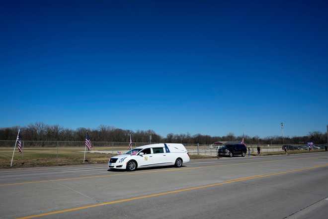 A hearse caravans in a procession for Iowa National Guard members Maj. Jeffrey O&amp;apos;Brien, of Waukee, Iowa, and Sgt. Declan Coady, of West Des Moines, Iowa, who both died when a drone hit a command center in Port Shuaiba, Kuwait, during the Iran Israel U.S. war, in Des Moines, Iowa, Thursday, March 19, 2026. (AP Photo/Charlie Neibergall)
