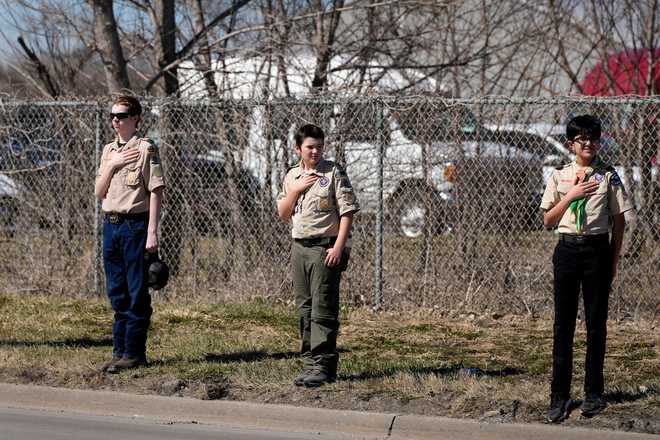 Scouts hold their hands over the hearts during a procession for Iowa National Guard members Maj. Jeffrey O&amp;apos;Brien, of Waukee, Iowa, and Sgt. Declan Coady, of West Des Moines, Iowa, who both died when a drone hit a command center in Port Shuaiba, Kuwait, during the Iran Israel U.S. war,  in Des Moines, Iowa, Thursday, March 19, 2026. (AP Photo/Charlie Neibergall)