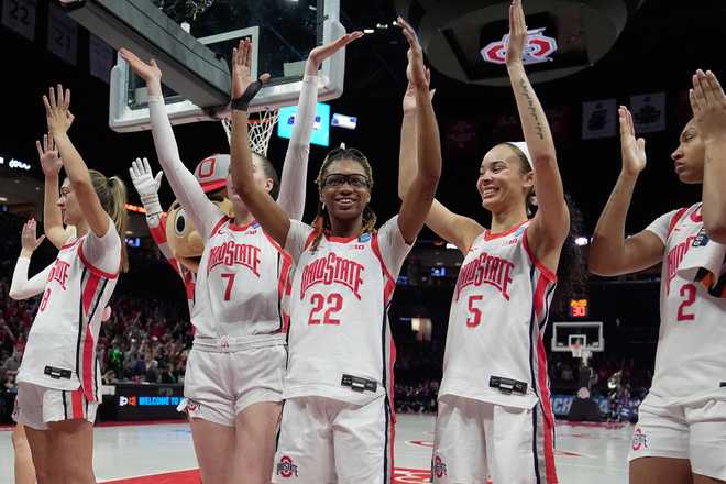 Ohio State players including Bryn Martin (8), Dasha Biriuk (7), Jaloni Cambridge (22), Ava Watson (5) and Chance Gray (2) celebrate after defeating Howard in the first round of the NCAA college basketball tournament, Saturday, March 21, 2026, in Columbus, Ohio. (AP Photo/Sue Ogrocki)