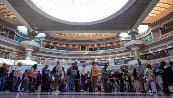 People wait in a TSA line at the Hartsfield-Jackson Atlanta International Airport, Monday, March 23, 2026, in Atlanta.
