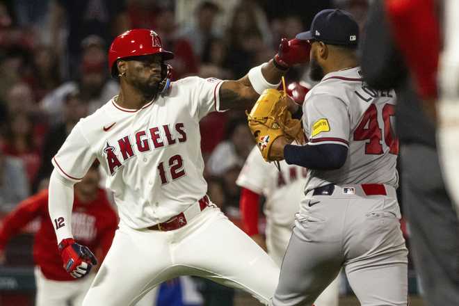 Los Angeles Angels' Jorge Soler (12) and Atlanta Braves' Reynaldo López (40) fight during the fifth inning of a baseball game, Tuesday, April 7, 2026, in Anaheim, Calif.